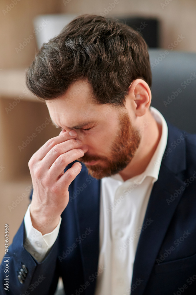 Close up of an executive or an office worker closing his eyes from the tiredness. Close up of an executive or an office worker closing his eyes from the tiredness.