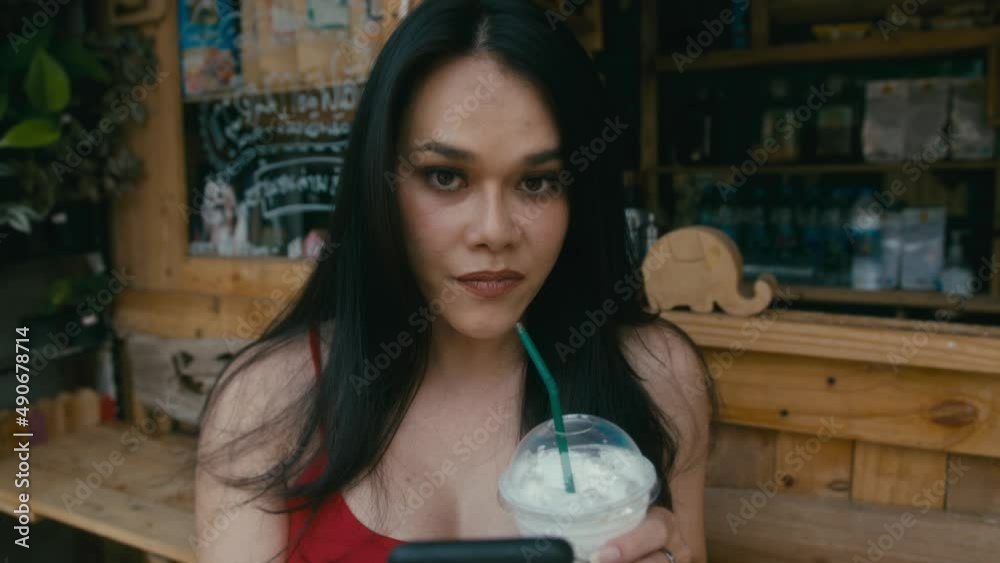 a beautiful trans woman chatting while walking down the street