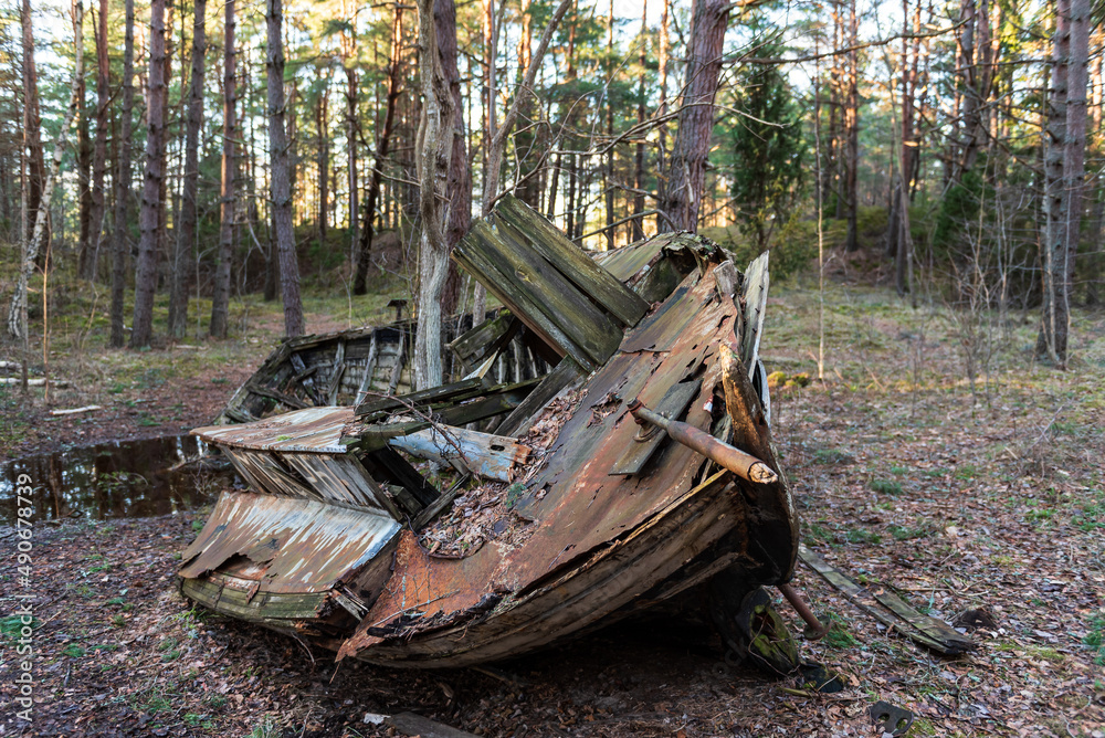 Old abandoned wooden fishing boat in the forest. Boat cemetery. Old abandoned wooden fishing boat in the forest. Boat cemetery.