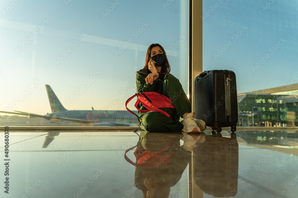 Woman calling by phone at the airport