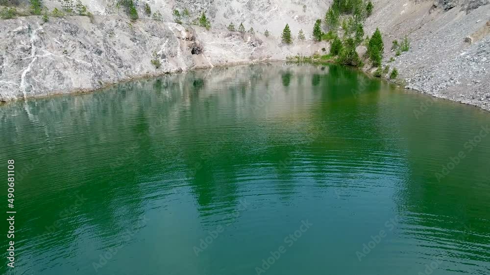 Dark green lake surrounded by conifers 04