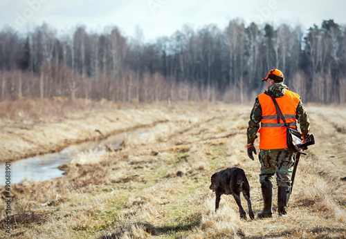 Pheasant hunting, hunter with dog photo