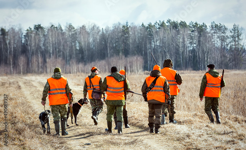 Fotografie, Obraz Hunters with dogs go to the forest during the hunting season