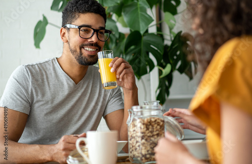 Happy couple having breakfast together in the kitchen