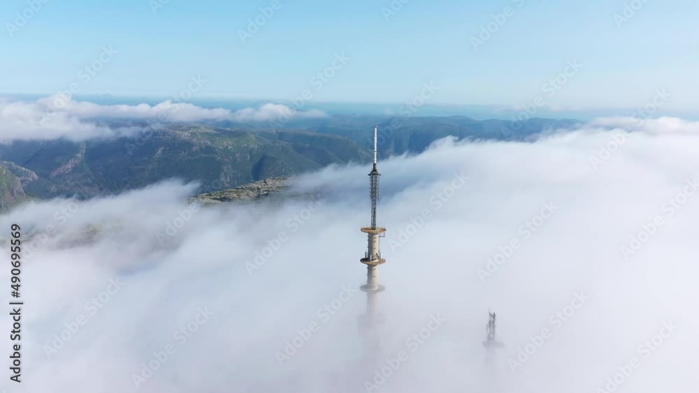 cicling radio tower with mountains in the background cicling radio tower with mountains in the background