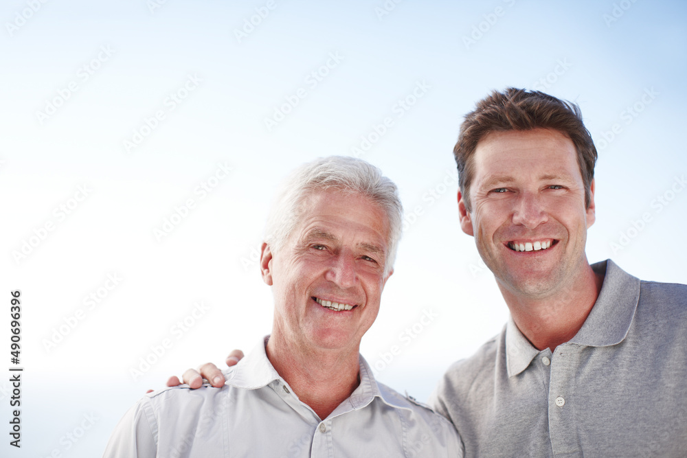 Like father, like son. Cropped portrait of a mature man and his senior father standing outside. Like father, like son. Cropped portrait of a mature man and his senior father standing outside.