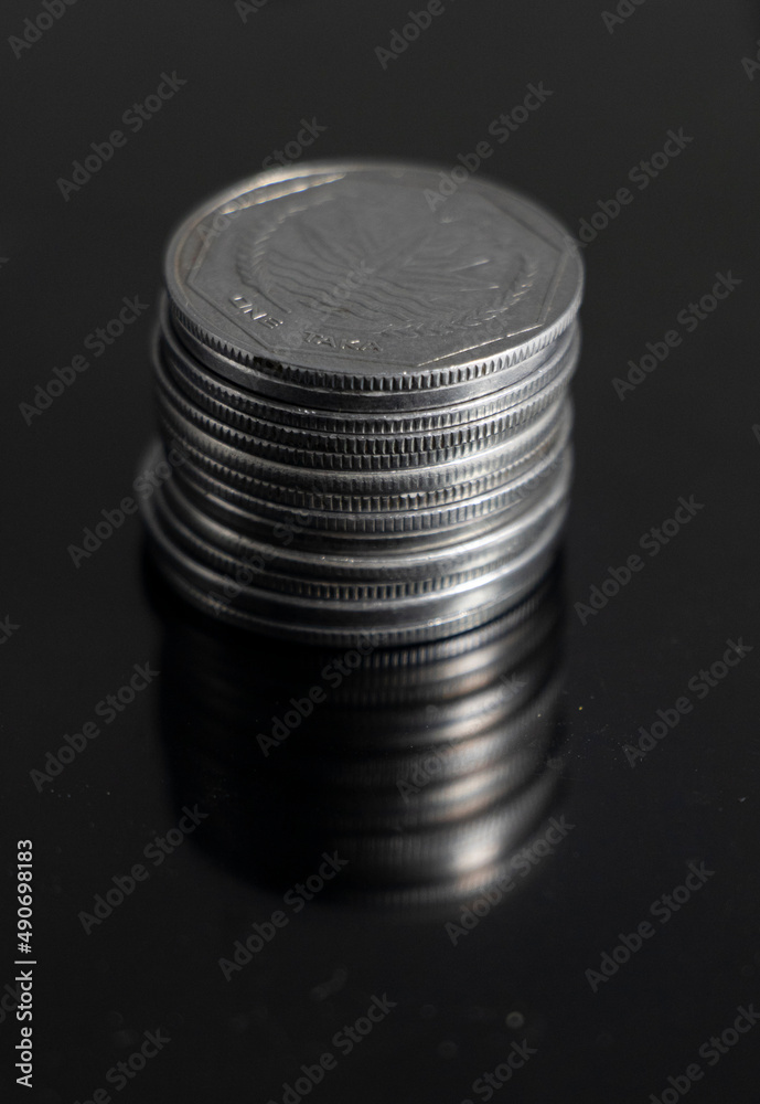 A pile of Coins stacks on a black background A pile of Coins stacks on a black background
