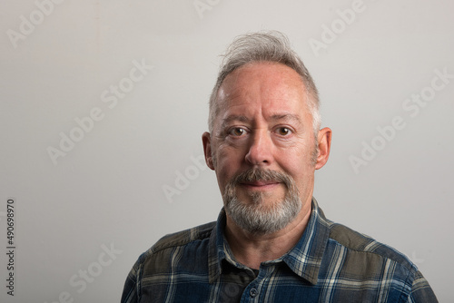 Close up photo of middle aged man, with beard and grey hair