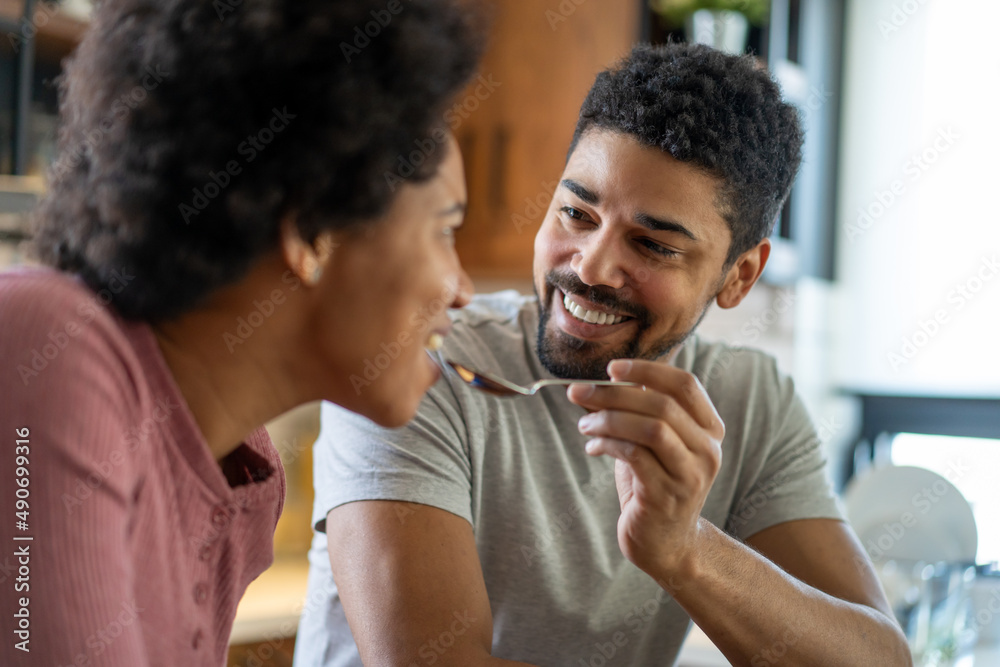Happy african american couple having breakfast together in the kitchen Happy african american couple having breakfast together in the kitchen