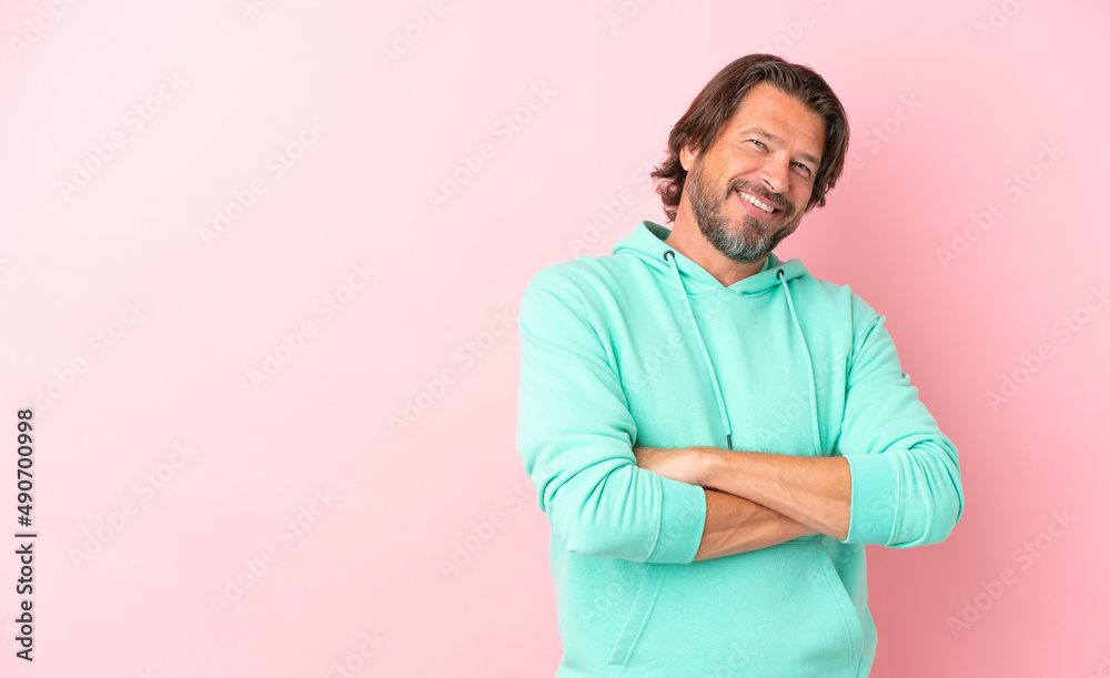 Senior dutch man isolated on pink background keeping the arms crossed in frontal position Senior dutch man isolated on pink background keeping the arms crossed in frontal position