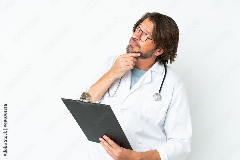 Senior dutch man isolated on white background wearing a doctor gown and holding a folder Senior dutch man isolated on white background wearing a doctor gown and holding a folder