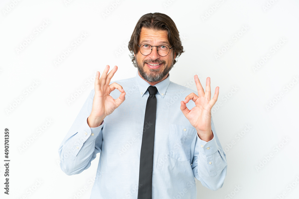 Senior dutch business man isolated on white background showing an ok sign with fingers Senior dutch business man isolated on white background showing an ok sign with fingers