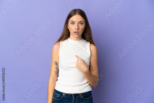 Young Lithuanian woman isolated on purple background pointing to oneself © luismolinero