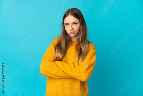 Young Lithuanian woman isolated on blue background feeling upset