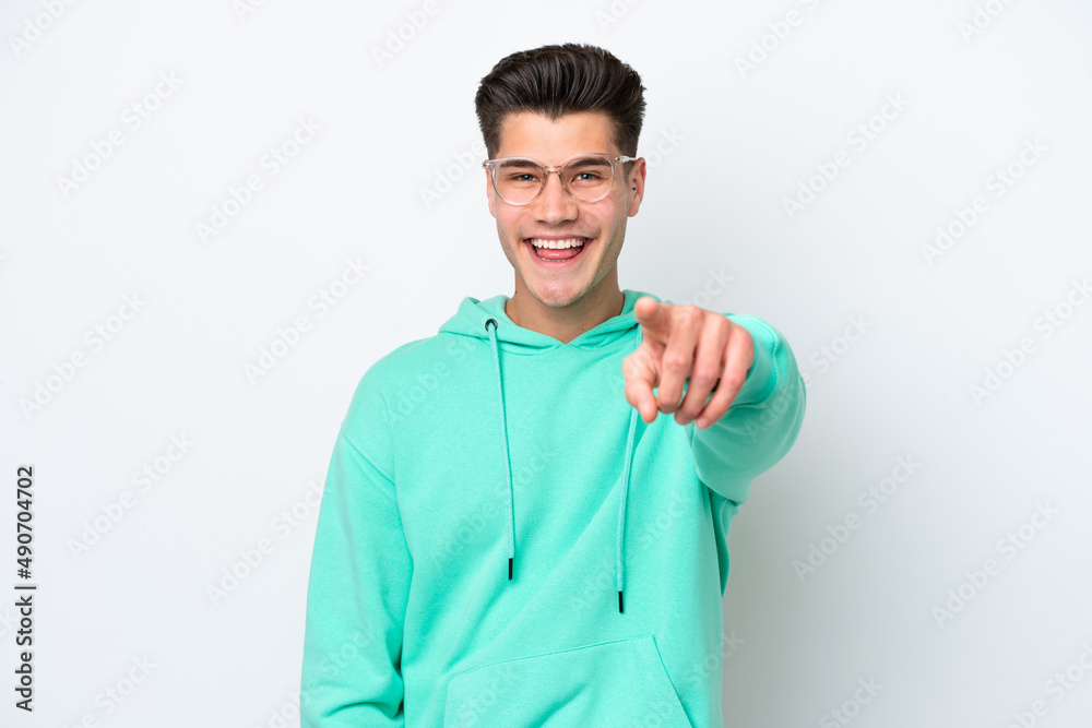 Young handsome caucasian man isolated on white bakcground surprised and pointing front Young handsome caucasian man isolated on white bakcground surprised and pointing front