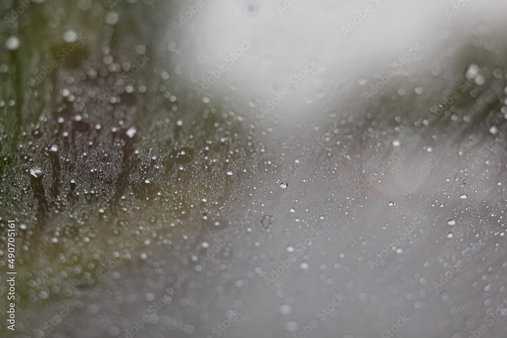 Close-up of water droplets on the windshield of a moving car Close-up of water droplets on the windshield of a moving car