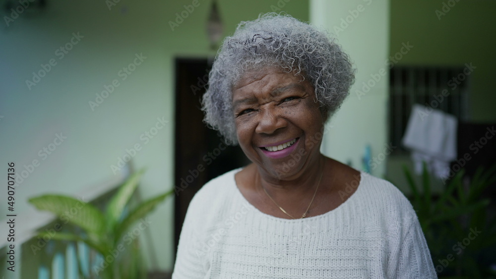 Happy senior woman in 70s smiling and laughing Happy senior woman in 70s smiling and laughing