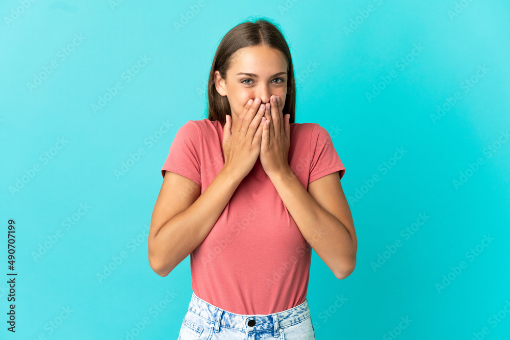Young woman over isolated blue background happy and smiling covering mouth with hands Young woman over isolated blue background happy and smiling covering mouth with hands
