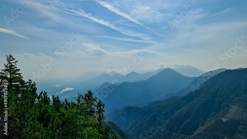 Scenic view on the alpine mountain chains of the Karawanks in Carinthia  Austria. Peaks are shrouded in morning fog. Mystical vibes. Clear and sunny day.  Serenity. View from Ferlacher Spitze  Alps
