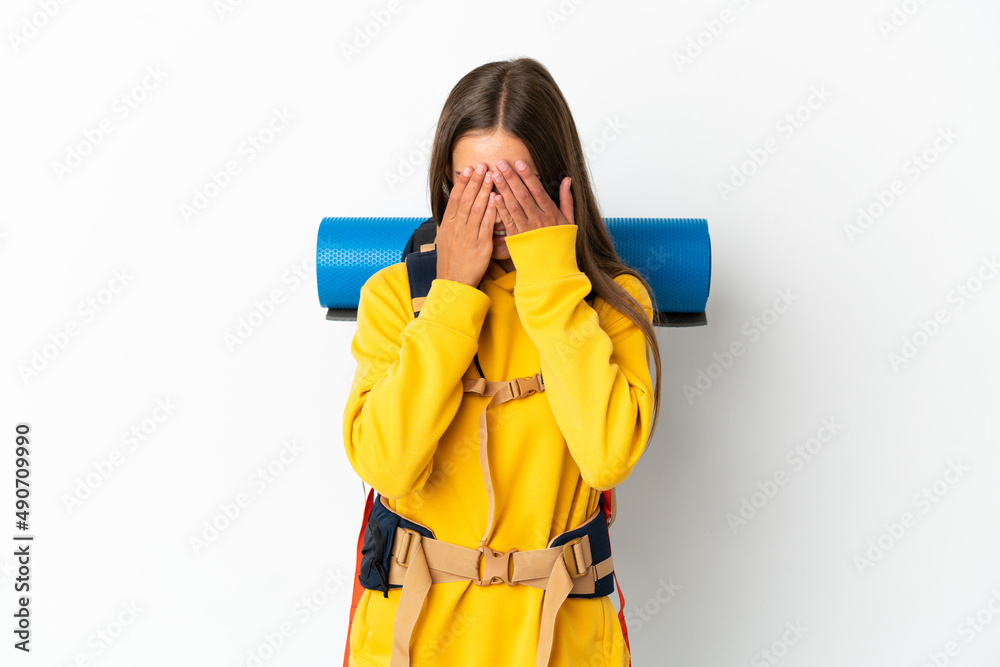 Young mountaineer woman with a big backpack over isolated white background with tired and sick expression Young mountaineer woman with a big backpack over isolated white background with tired and sick expression