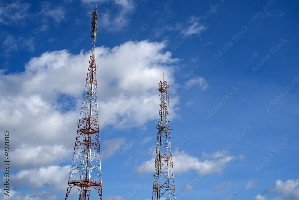 2 white-red antenna with sky and clouds background. 2 white-red antenna with sky and clouds background.