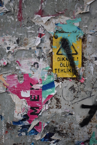 Street Art (torn manifestos and a warning sign with graffiti) 