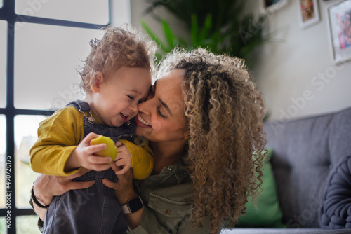 Mother and Toddler cuddling and sharing an apple photo