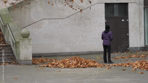 Woman play racquetball alone in autumn street. photo