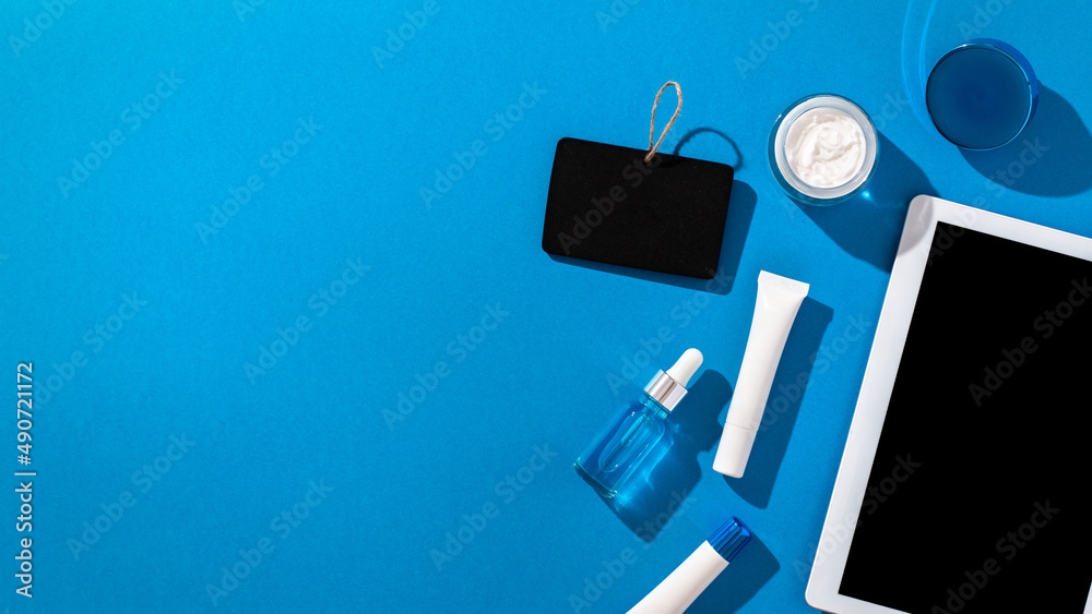 Skin care cosmetics protecting from gadgets blue light on blue background