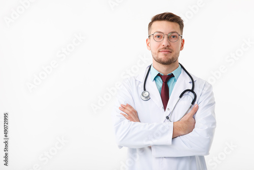 Portrait of confident young medical doctor on white background. © Aleksandr Rybalko