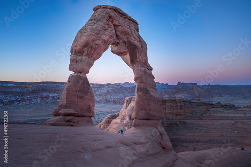Yoga pose 'wheel' under Delicate Arch in Arches National Park, Utah