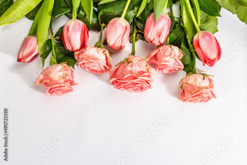 Bouquet of fresh delicate roses and tulips isolated on white background. Romantic gift concept