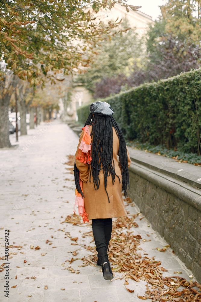 Back view photo of a woman in a coat walking outside