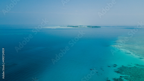 Fototapeta Naklejka Na Ścianę i Meble -  Aerial View to the Maafushi (Kaafu Atoll) Paradise Island with Blue Ocean Water and Paradise Coastline, Maldives