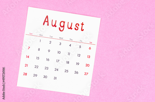 August 2022 calendar on pink background with empty space.