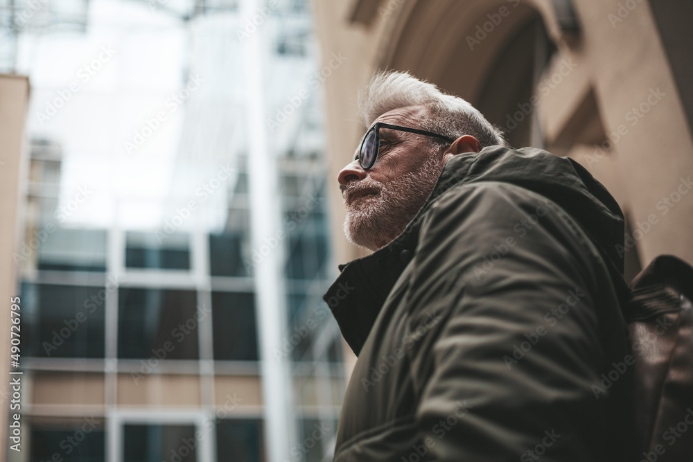 Obraz premium Portrait of a mature man in thought. Lonely traveler, refugee.