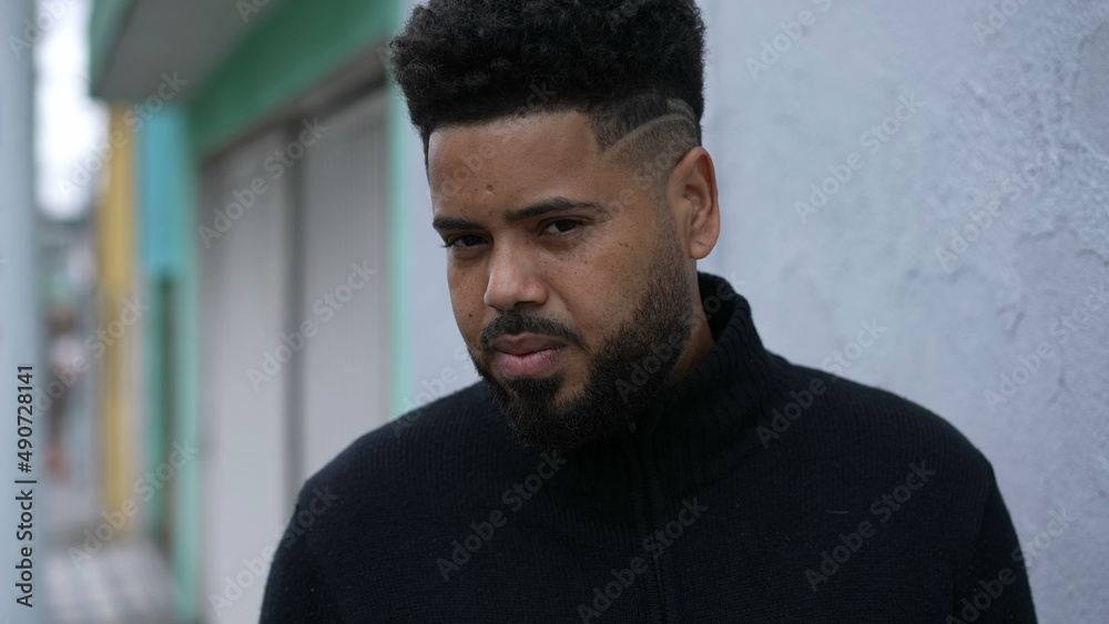 A thoughtful black man standing in urban street a thoughtful person A thoughtful black man standing in urban street a thoughtful person