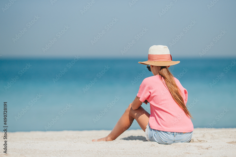 Adorable little girl have fun at tropical beach during vacation Adorable little girl have fun at tropical beach during vacation