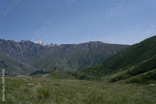 The mountain ranges of Georgia, Kazbegi, where two mountains form a triangular shape and above them a mountain spice that is covered with white snow