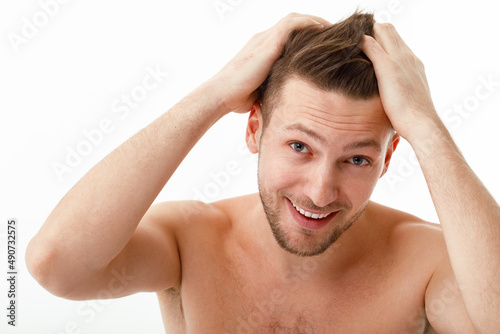 The young man was upset when he noticed his gray hair. Hair care, baldness graying.