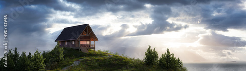 A-frame Cabin home on the ocean coast. Dramatic Sky. 3d Rendering. Nature landscape background from Pacific Ocean of Alaska, USA. Sunny Morning Artwork © edb3_16