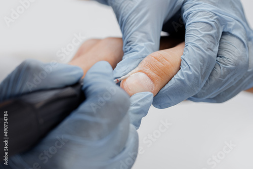 Closeup hands of man gets professional manicure care in spa salon