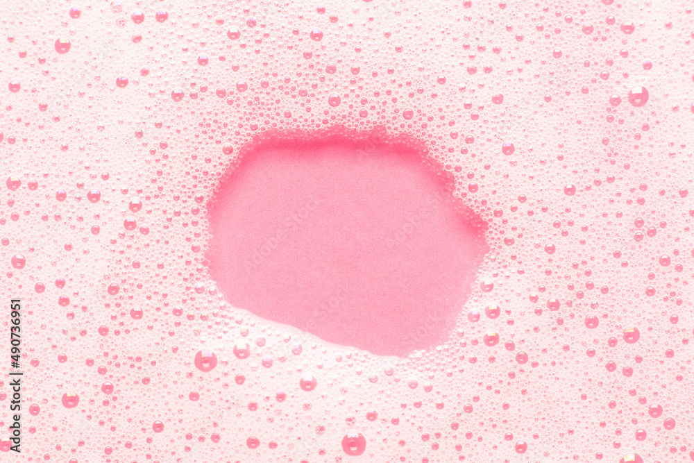 Hygiene, bubbles and foam on a pink background, empty space for text. Template and layout for cosmetics.