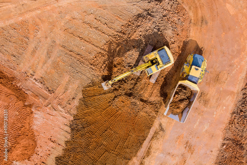 Excavation and loading onto dump trucks with excavators work construction equipment for earthworks photo