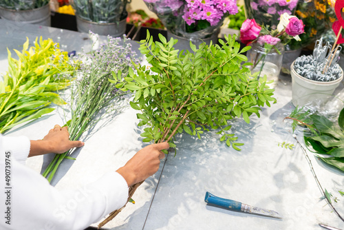 Unrecognizable florist with pistacia branches photo
