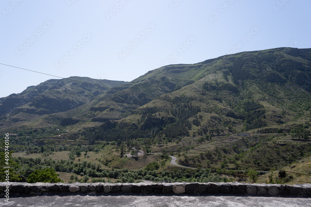 view of a large crop field from the highway where you can see the roadside barrier
