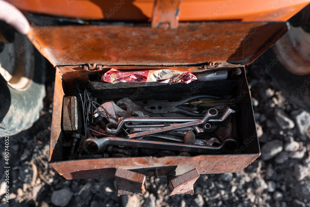 Different tools of tractor repairment in container Different tools of tractor repairment in container