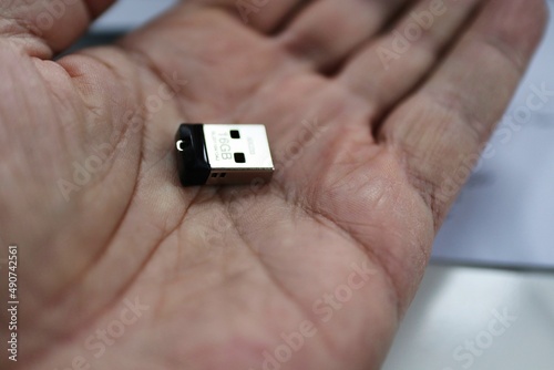 Open palm hand with thumb drive