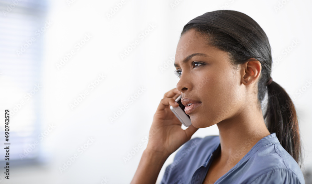 Staying in touch. A beautiful young ethnic woman speaking on her cellphone - copyspace. Staying in touch. A beautiful young ethnic woman speaking on her cellphone - copyspace.
