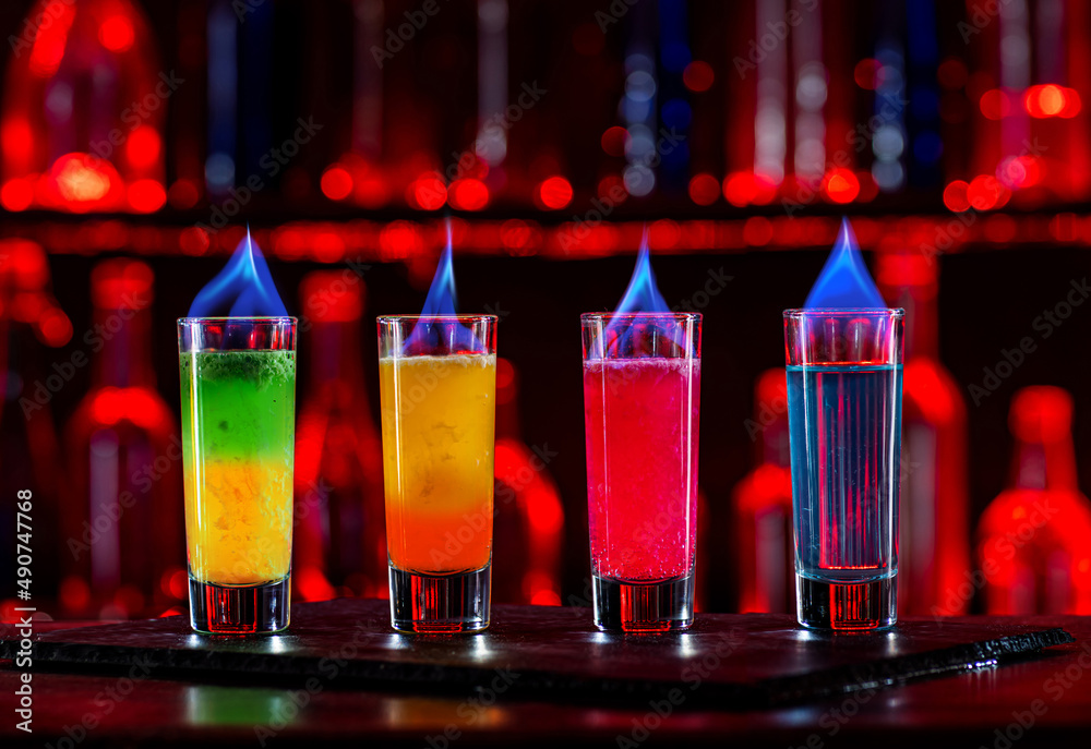 Cocktails Party Shots and Shooters on bar counter in a restaurant, pub.  Miniature mixed drinks. Alcoholic cooler beverage at nightclub on dark  background Stock Photo | Adobe Stock